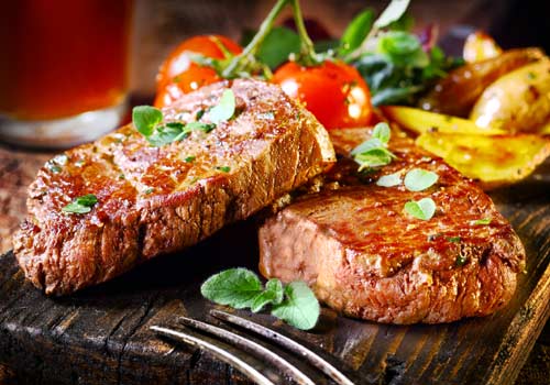 steaks garnished with vegetables